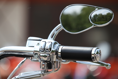 closeup of motorcycle handle and mirror