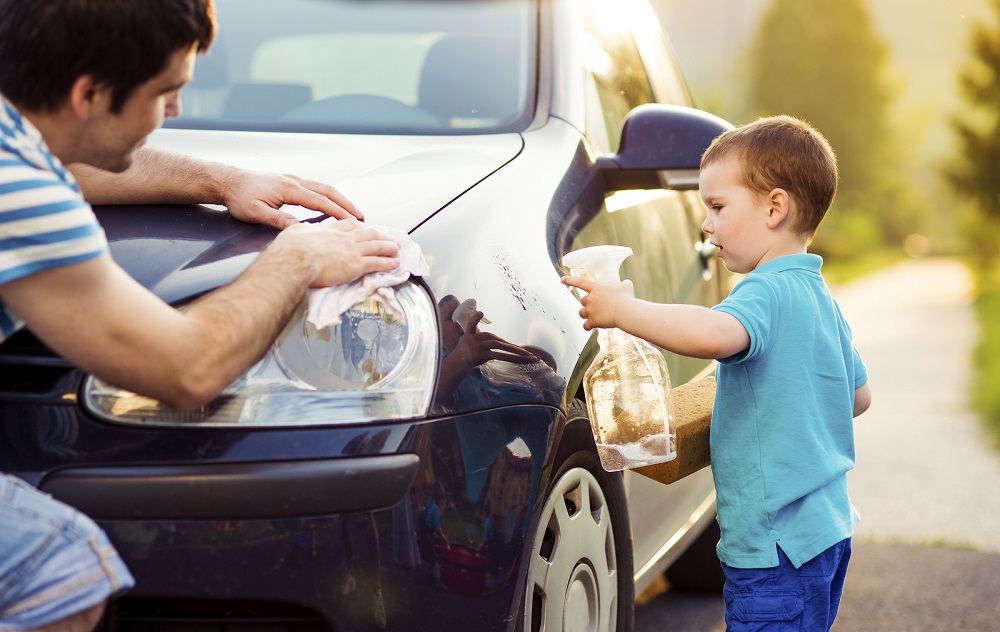 Father and son washing car