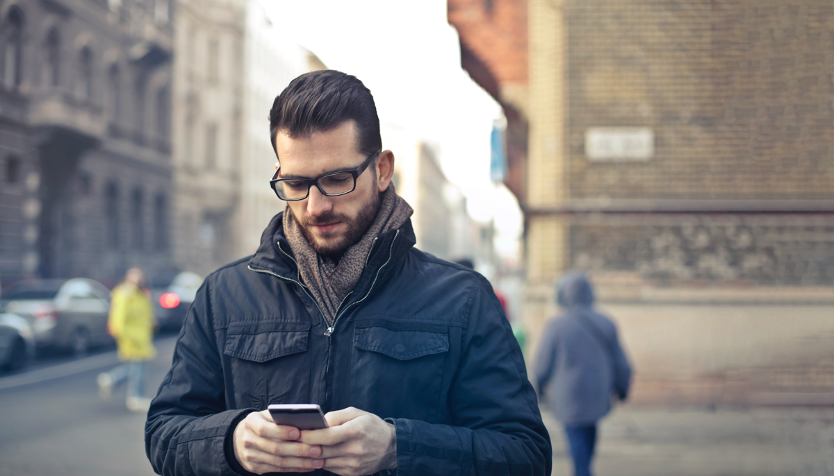 guy in jacket with his phone