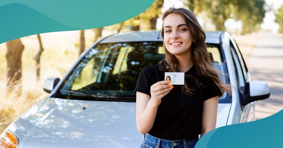 Teen driver holding her license