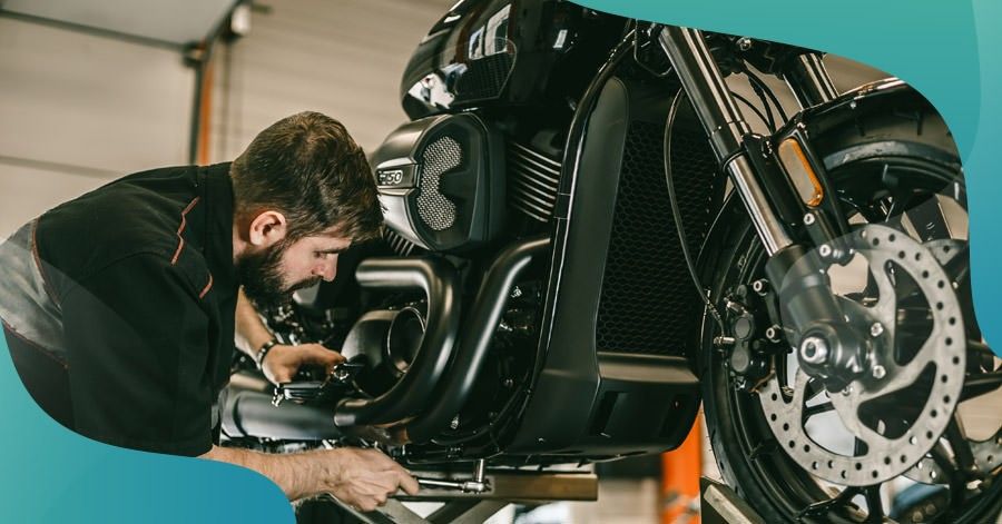 man performing motorcycle maintenance on a bike