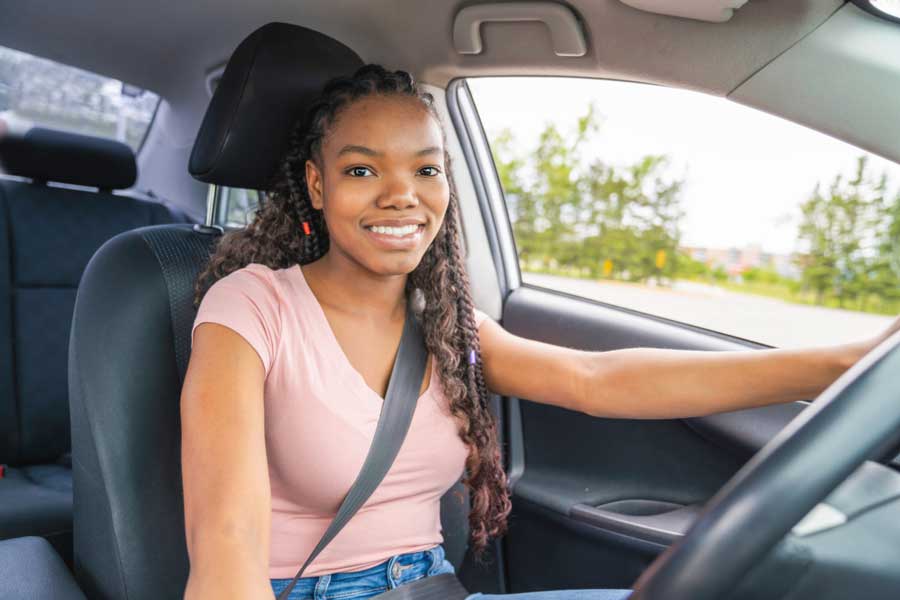 Teen driver safely buckled into new car.